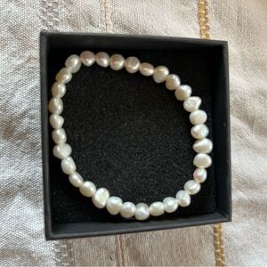 Pearl costume bracelet. Stretches.